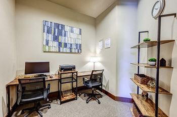 a home office with two desks and a computer
